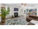 Spacious living room with hardwood floors, fireplace, large windows, and a view of the eat-in kitchen at 512 Red Oak Ct, Tega Cay, SC 29708