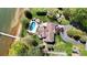 Breathtaking aerial view of property featuring a pool, dock, expansive lawn, and lake frontage at 7424 Windy Pine Cir, Denver, NC 28037