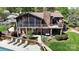 Multi-level deck, stone accents, and a screened porch with a pool and lake views, perfect for outdoor living at 7424 Windy Pine Cir, Denver, NC 28037