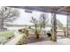 Outdoor back porch looking out to the lake, swimming pool, and a meticulously landscaped yard at 7424 Windy Pine Cir, Denver, NC 28037