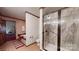 The bathroom features a tiled walk-in shower, a soaking tub, and wood paneling at 7424 Windy Pine Cir, Denver, NC 28037