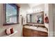 Bathroom featuring a custom vanity, decorative mirror, and updated fixtures at 7424 Windy Pine Cir, Denver, NC 28037