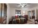 This cozy bedroom has a daybed with decorative pillows and blanket, ceiling fan, and access to another room at 7424 Windy Pine Cir, Denver, NC 28037