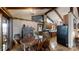 The dining room features wood floors, a wood dining table, and exposed wooden beams at 7424 Windy Pine Cir, Denver, NC 28037
