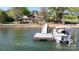 Lakeside home with private dock and boat featuring waterfront views and natural surroundings at 7424 Windy Pine Cir, Denver, NC 28037