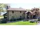 Stone-clad home with lush green lawn and mature trees; features a side-entry garage at 7424 Windy Pine Cir, Denver, NC 28037