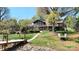 Beautiful waterfront property with stone facade, dock, mature trees, and landscaped yard at 7424 Windy Pine Cir, Denver, NC 28037