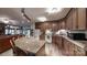The kitchen boasts warm wood cabinetry and granite countertops plus seamless flow to living spaces at 7424 Windy Pine Cir, Denver, NC 28037