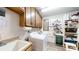 This organized laundry room features a sink, storage cabinets, washer, dryer, and shelving for supplies at 7424 Windy Pine Cir, Denver, NC 28037