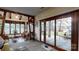 Relaxing living room with exposed beams, many windows, comfortable seating area, and a view of the lake at 7424 Windy Pine Cir, Denver, NC 28037