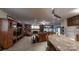 Open-concept living and dining space with a stone fireplace, seamlessly connected to the kitchen at 7424 Windy Pine Cir, Denver, NC 28037