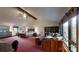 This bedroom has a vaulted ceiling with exposed beams and a sitting area by the window at 7424 Windy Pine Cir, Denver, NC 28037