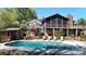 A backyard pool with lounge chairs sits near a charming home with a screened porch at 7424 Windy Pine Cir, Denver, NC 28037