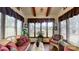 Bright sunroom featuring lots of natural light and nature views, tile floor, and cozy wicker seating at 7424 Windy Pine Cir, Denver, NC 28037