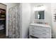 Bright bathroom featuring a vanity with marble countertop and a shower with a patterned curtain at 7545 Brancy St, Kannapolis, NC 28081
