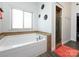 Bright bathroom with large tub, glass shower, and stylish decor for a relaxing spa-like experience at 7545 Brancy St, Kannapolis, NC 28081