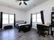 Comfortable bedroom with a black metal bedframe, ceiling fan, natural light and space for a desk at 7545 Brancy St, Kannapolis, NC 28081