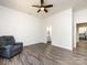 Another view of the spacious bedroom with a comfortable armchair, and ceiling fan at 7545 Brancy St, Kannapolis, NC 28081