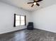 Spacious bedroom featuring a comfortable armchair, ceiling fan, and window for natural light at 7545 Brancy St, Kannapolis, NC 28081