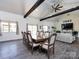 Open dining room with large table, vaulted ceiling, exposed beams and view to the living room at 7545 Brancy St, Kannapolis, NC 28081