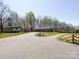 Long paved driveway leading to a cozy, single-story home with an RV, a storage building and a deer ornament at 7545 Brancy St, Kannapolis, NC 28081