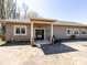 A beige home featuring a covered entrance with pillars and a solid black door with white trim windows at 7545 Brancy St, Kannapolis, NC 28081