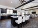 Spacious kitchen with dark cabinets, granite countertops, large island with bar stools, and exposed ceiling beams at 7545 Brancy St, Kannapolis, NC 28081