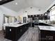 A kitchen boasting stainless steel appliances, granite countertops, a large island, and wood laminate flooring at 7545 Brancy St, Kannapolis, NC 28081