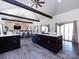 Spacious kitchen island with granite countertops, dark wood cabinets, and open floor plan to living and dining area at 7545 Brancy St, Kannapolis, NC 28081
