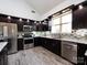 Modern kitchen featuring dark cabinets, granite countertops, stainless steel appliances, and stylish backsplash at 7545 Brancy St, Kannapolis, NC 28081