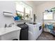 Well-equipped laundry room with modern washer and dryer, sink, and organized shelving at 7545 Brancy St, Kannapolis, NC 28081