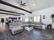 Bright living room with large sectional sofa, vaulted ceiling, exposed beams, with views of the kitchen and dining area at 7545 Brancy St, Kannapolis, NC 28081