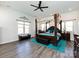 Large main bedroom with four-poster bed, decorative accents, ceiling fan and lots of natural light at 7545 Brancy St, Kannapolis, NC 28081