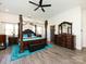 Spacious main bedroom suite featuring a four-poster bed, ceiling fan, and ample natural light from the large windows at 7545 Brancy St, Kannapolis, NC 28081