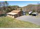 Spacious workshop near a pond, complete with a garage door, a smaller outbuilding, and room for parking at 7545 Brancy St, Kannapolis, NC 28081