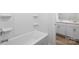 Contemporary bathroom with a clean white bathtub and tiled wall at 7730 Woolsey Dr, Gastonia, NC 28056