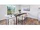 Modern dining area features a sleek wood table with seating for six and bright sliding door for natural light at 7730 Woolsey Dr, Gastonia, NC 28056