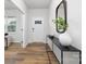 Inviting entryway with wood flooring, a console table, and a modern mirror at 7730 Woolsey Dr, Gastonia, NC 28056