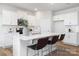 Bright white kitchen with an island, stainless steel appliances, and modern countertops at 7730 Woolsey Dr, Gastonia, NC 28056