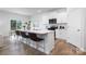 Modern white kitchen featuring a center island with seating, stainless appliances, and white cabinets at 7730 Woolsey Dr, Gastonia, NC 28056