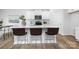 Modern white kitchen featuring a center island with seating, stainless appliances, and white cabinets at 7730 Woolsey Dr, Gastonia, NC 28056