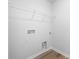 Dedicated laundry area with hookups, shelves, and durable flooring at 7730 Woolsey Dr, Gastonia, NC 28056