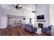 Open-concept living room features wood floors, fireplace, high ceilings, and modern furnishings at 7730 Woolsey Dr, Gastonia, NC 28056