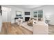 Inviting living room has a fireplace, a cozy seating area, and large windows that flood the space with sunlight at 7730 Woolsey Dr, Gastonia, NC 28056
