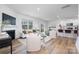 Expansive living area connects the fireplace lounge, dining space, and kitchen island for ultimate comfort at 7730 Woolsey Dr, Gastonia, NC 28056