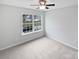 Bright, minimalist bedroom with a large window providing natural light at 78162 Rillstone Dr, Lancaster, SC 29720