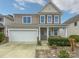 Charming two-story home with a well-manicured lawn, attached garage, and welcoming front porch at 78162 Rillstone Dr, Lancaster, SC 29720