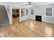 Bright living room with fireplace, hardwood floors, and view to kitchen create a warm, open space at 78162 Rillstone Dr, Lancaster, SC 29720