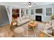 Bright living room with fireplace, hardwood floors, and view to kitchen create a warm, open space at 78162 Rillstone Dr, Lancaster, SC 29720