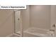 Bathroom features a shower with glass doors and white fixtures at 8067 Kennesaw Dr, Gastonia, NC 28056